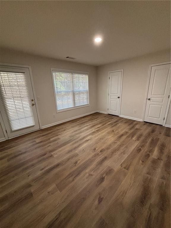 spare room featuring dark hardwood / wood-style flooring