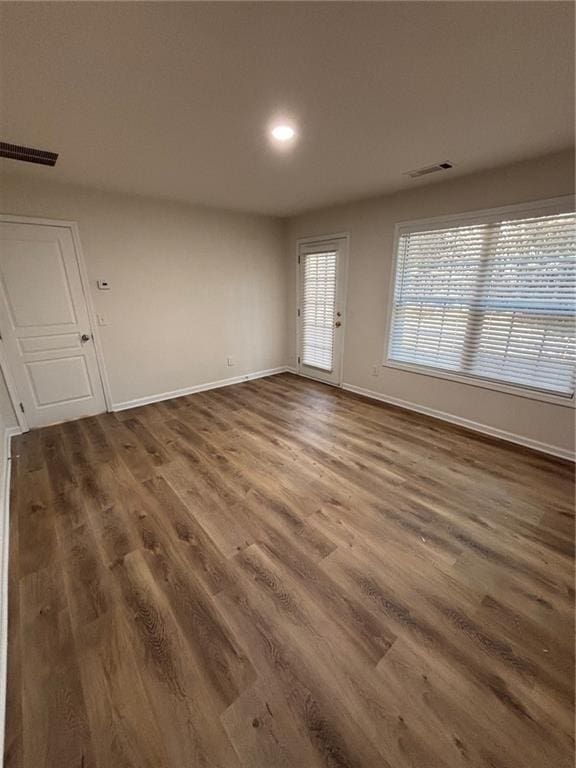 spare room featuring dark wood-type flooring