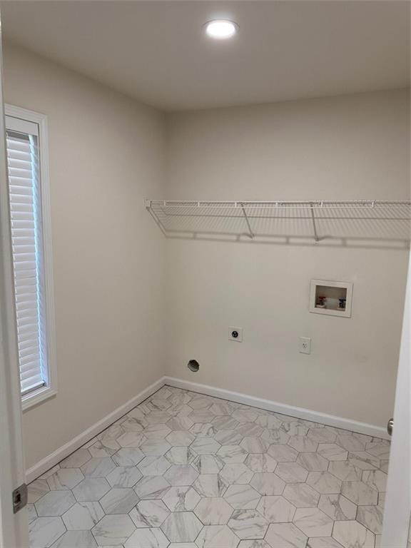 clothes washing area with washer hookup and hookup for an electric dryer