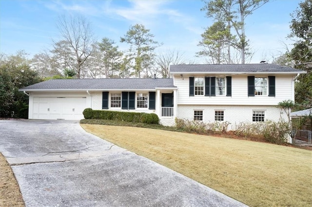 split level home with a garage and a front yard