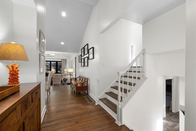 corridor with lofted ceiling and dark hardwood / wood-style flooring