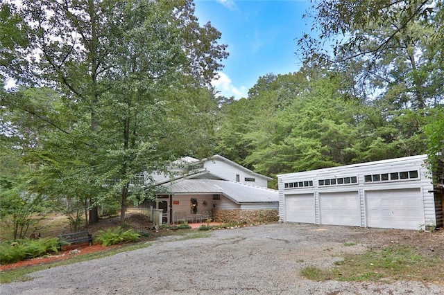 view of front of home featuring a detached garage and metal roof