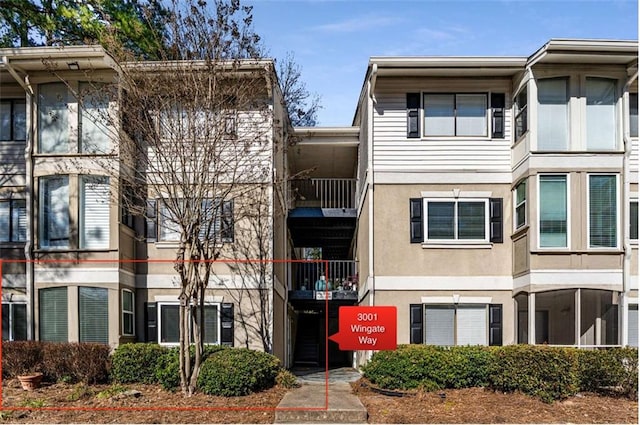 view of property with stairs and central AC unit