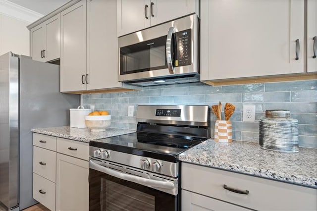 kitchen with tasteful backsplash, stainless steel appliances, light stone counters, and ornamental molding