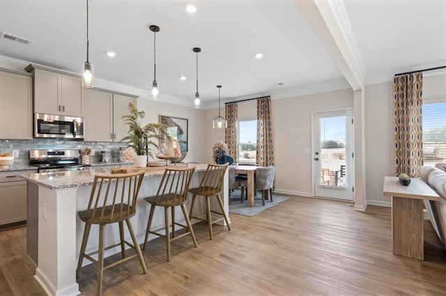 kitchen featuring visible vents, backsplash, appliances with stainless steel finishes, and gray cabinetry