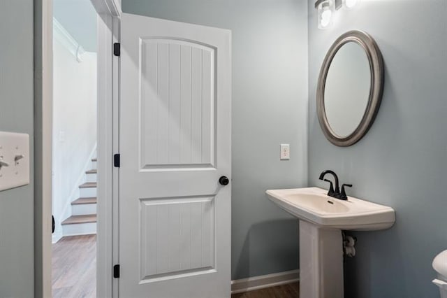 bathroom featuring toilet, baseboards, and wood finished floors