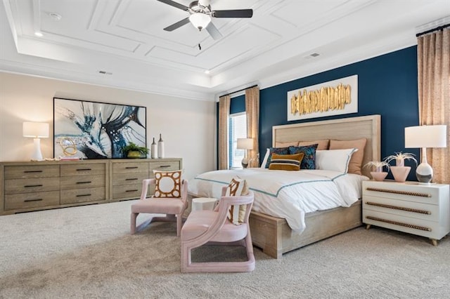 carpeted bedroom with a ceiling fan, a tray ceiling, and crown molding