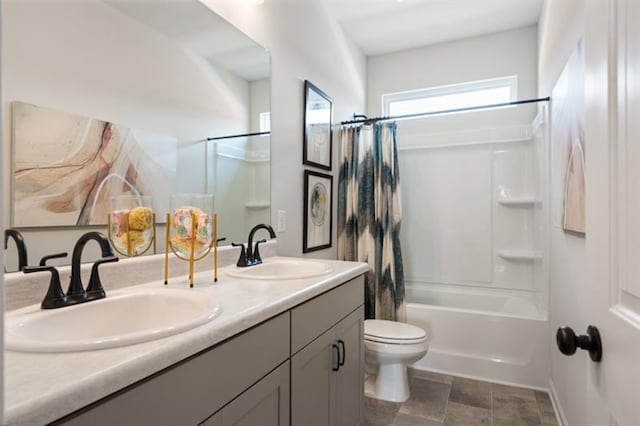 full bath with a sink, toilet, double vanity, and shower / tub combo