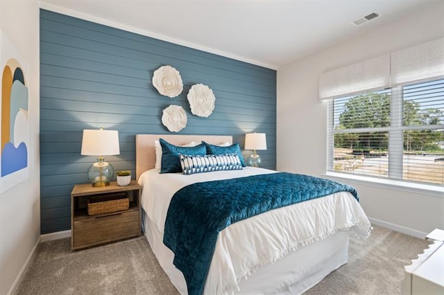 carpeted bedroom with visible vents and baseboards