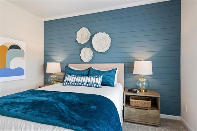 bedroom featuring carpet and baseboards