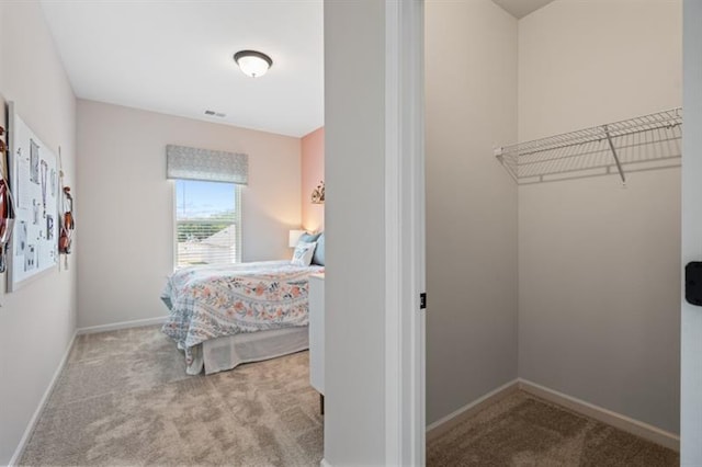 interior space featuring visible vents, baseboards, and carpet floors