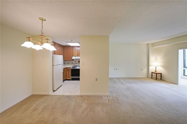 1800 Clairmont Lk Unit 213, Decatur, GA 30033 - kitchen featuring range, freestanding refrigerator, ventilation hood, light carpet, and a textured ceiling