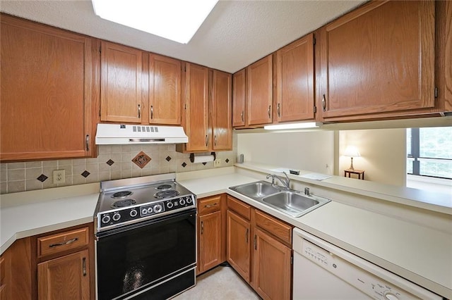 1800 Clairmont Lk Unit 213, Decatur, GA 30033 - kitchen with electric range, dishwasher, under cabinet range hood, a sink, and light countertops