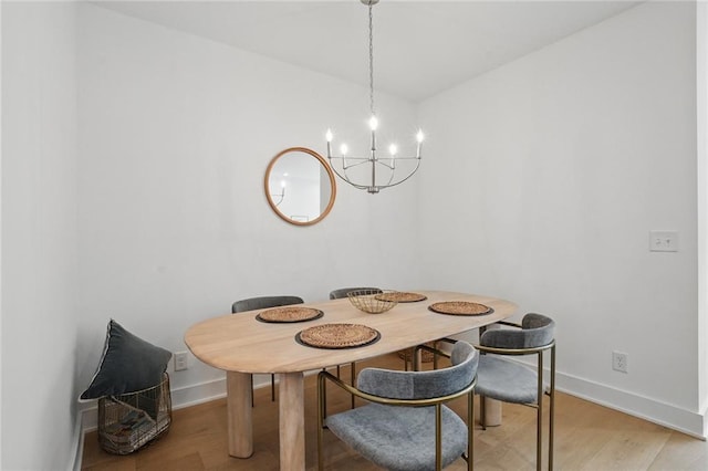 230 New St Unit 2102, Decatur, GA 30030 - dining room featuring baseboards, light wood-type flooring, and a chandelier
