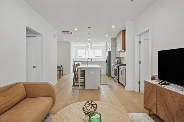 230 New St Unit 2102, Decatur, GA 30030 - living room featuring light wood-style floors, baseboards, recessed lighting, and visible vents