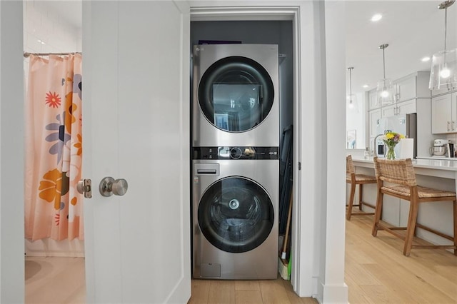 230 New St Unit 2102, Decatur, GA 30030 - laundry room featuring light wood-style floors, stacked washer and dryer, recessed lighting, and laundry area