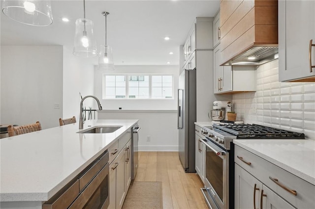230 New St Unit 2102, Decatur, GA 30030 - kitchen with decorative backsplash, custom range hood, a sink, light wood-style flooring, and stainless steel appliances