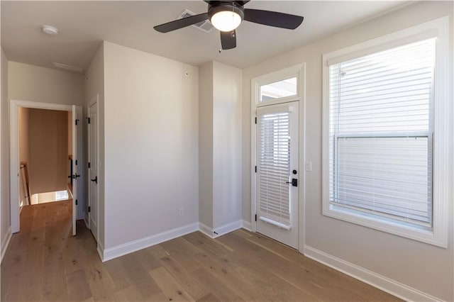 entryway with ceiling fan and light hardwood / wood-style floors