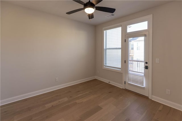 spare room with ceiling fan and dark hardwood / wood-style floors