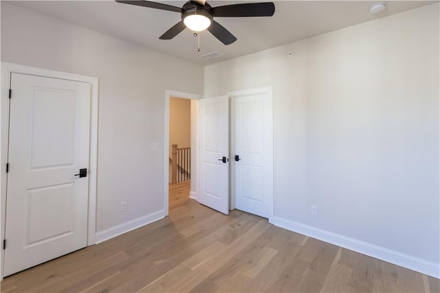 unfurnished bedroom featuring ceiling fan and light wood-type flooring