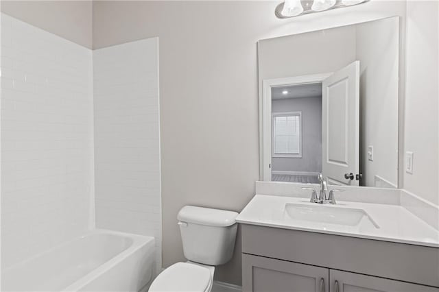 full bathroom featuring vanity, bathtub / shower combination, and toilet