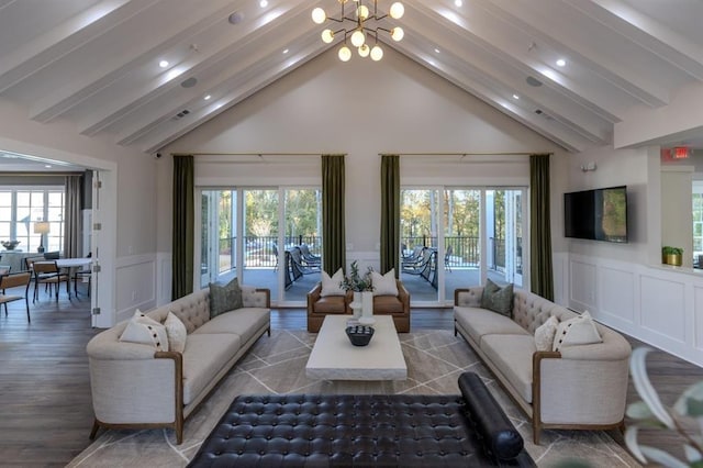 living room featuring dark hardwood / wood-style floors, a healthy amount of sunlight, a notable chandelier, and beam ceiling