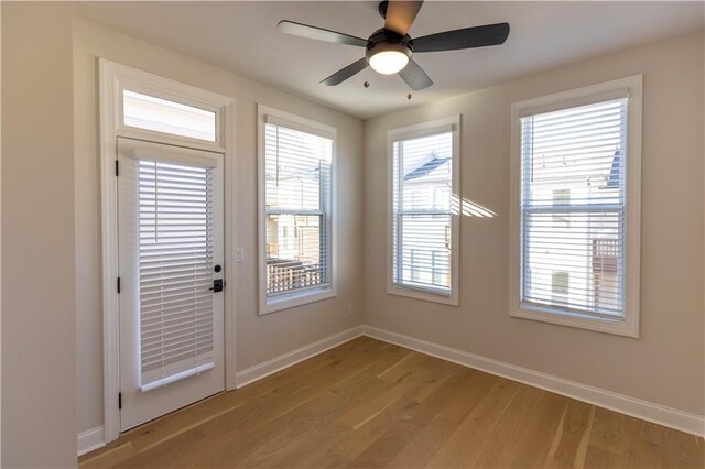 empty room with hardwood / wood-style flooring and ceiling fan