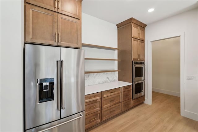 kitchen featuring light hardwood / wood-style floors and appliances with stainless steel finishes