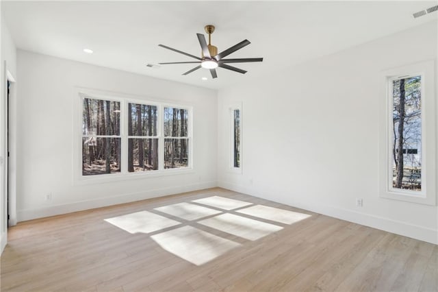 spare room featuring light wood-type flooring and ceiling fan