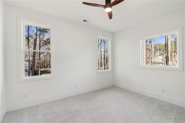 spare room featuring ceiling fan and carpet floors