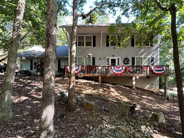 rear view of house featuring a wooden deck