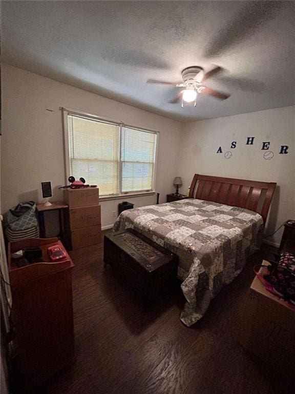 bedroom featuring a textured ceiling, ceiling fan, and dark hardwood / wood-style floors