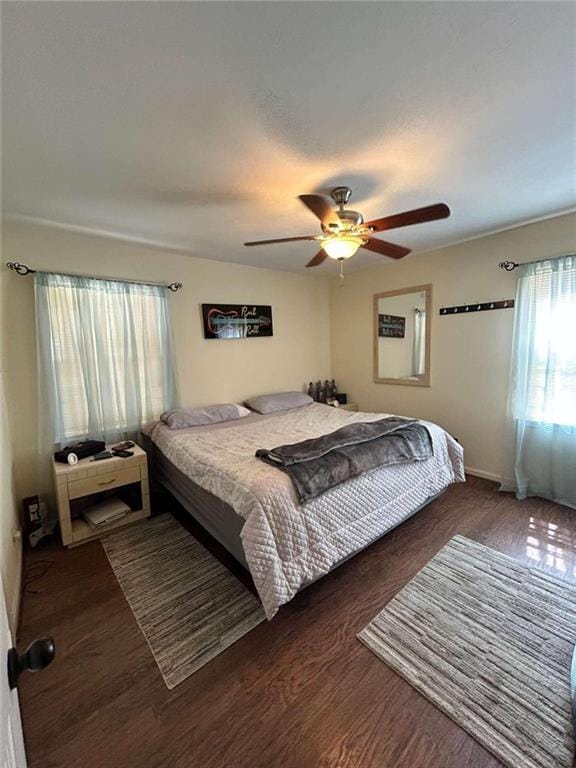 bedroom featuring dark wood-type flooring and ceiling fan