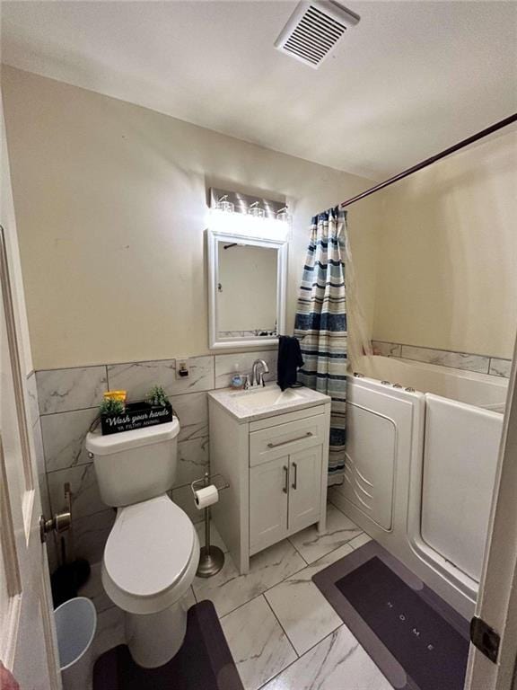 full bathroom featuring vanity, tile walls, toilet, and shower / bath combination with curtain