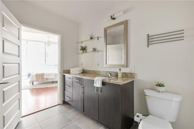 bathroom featuring vanity, toilet, and tile patterned flooring