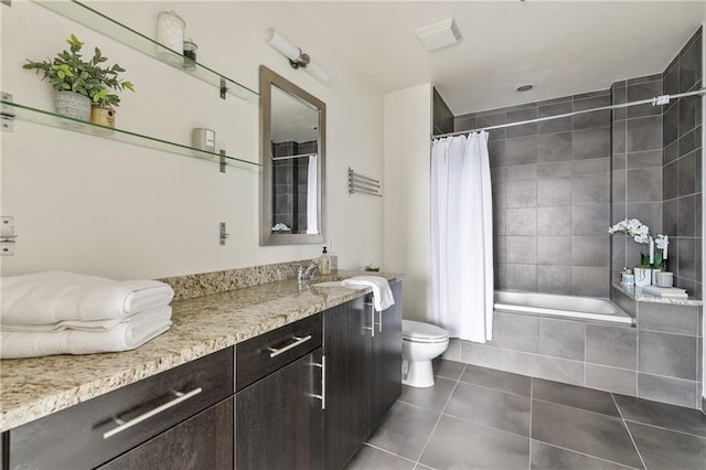 full bathroom featuring tile patterned flooring, vanity, shower / bath combo with shower curtain, and toilet