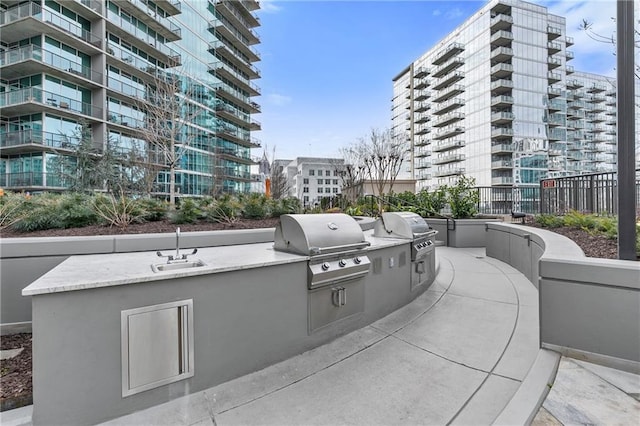 view of patio / terrace with area for grilling, an outdoor kitchen, and sink