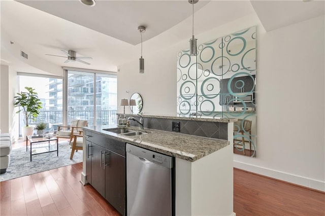 kitchen with dishwasher, dark hardwood / wood-style floors, a wall of windows, and decorative light fixtures