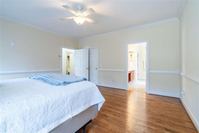 bedroom featuring connected bathroom, ceiling fan, baseboards, ornamental molding, and wood finished floors