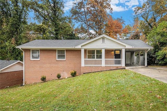 ranch-style house featuring a carport, covered porch, and a front lawn