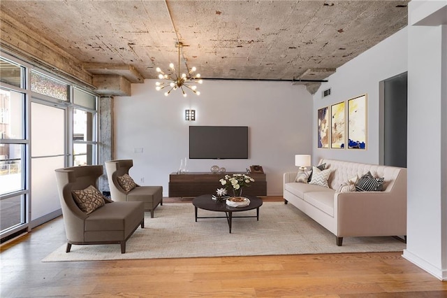 living room with light hardwood / wood-style flooring and a notable chandelier