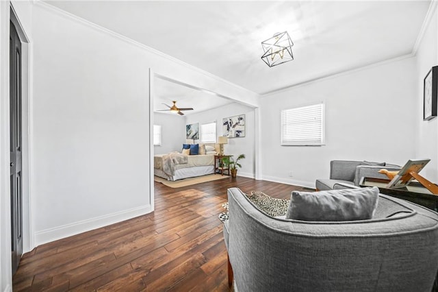 living room featuring ceiling fan, crown molding, and dark hardwood / wood-style floors