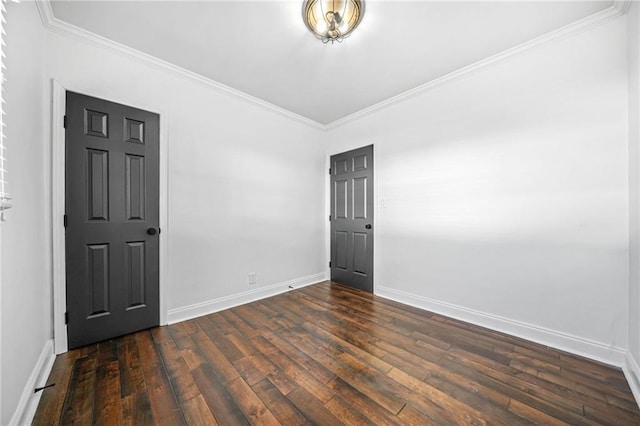 spare room with dark wood-type flooring and crown molding