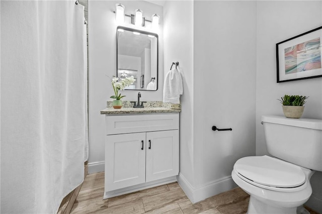 bathroom with toilet and vanity