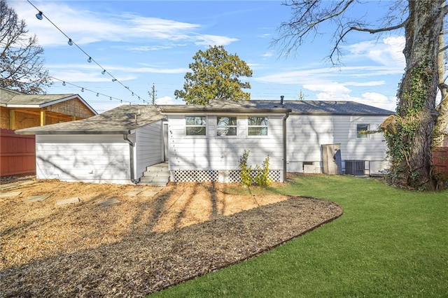 back of property featuring cooling unit and a yard