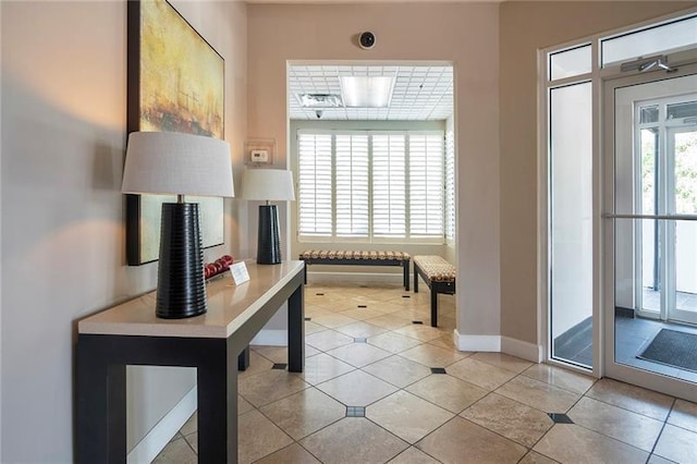 entryway featuring light tile patterned floors and baseboards