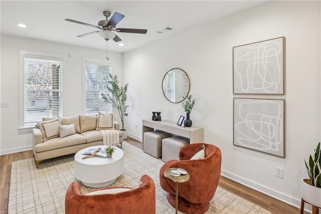 living area with light wood finished floors, baseboards, visible vents, and recessed lighting