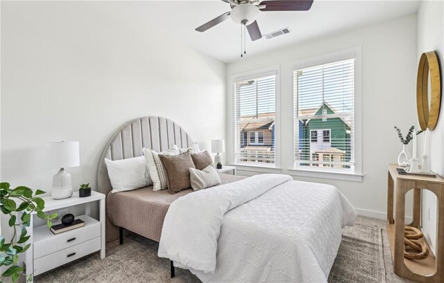 carpeted bedroom featuring visible vents, ceiling fan, and baseboards