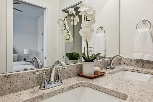 bathroom featuring a sink, ensuite bath, and double vanity