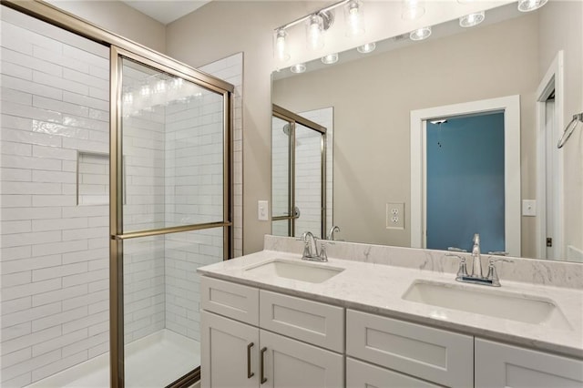 bathroom featuring an enclosed shower and vanity